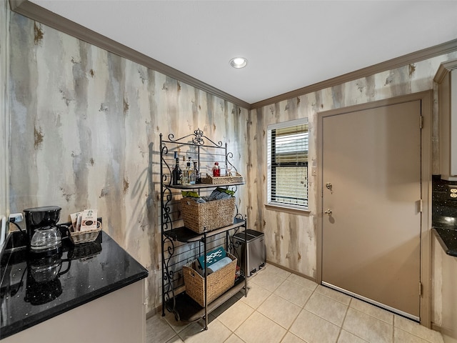 entrance foyer featuring light tile patterned flooring and ornamental molding