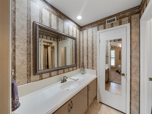 bathroom with ceiling fan, vanity, crown molding, and tile patterned floors