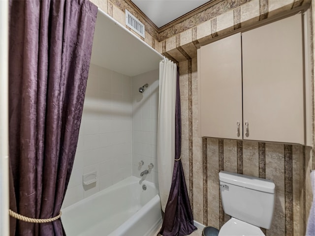 bathroom featuring toilet and shower / bathtub combination with curtain