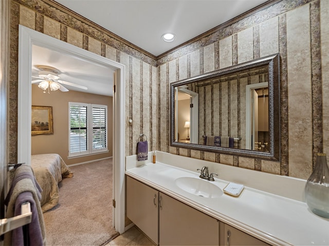 bathroom with crown molding, vanity, and ceiling fan