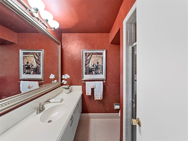 bathroom with vanity, a textured ceiling, tile patterned flooring, and an enclosed shower