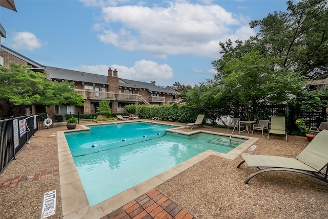 view of swimming pool featuring a patio area