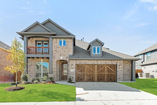 view of front of property with a garage, a balcony, and a front lawn