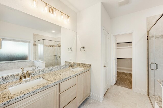 bathroom with tile patterned floors, vanity, and an enclosed shower