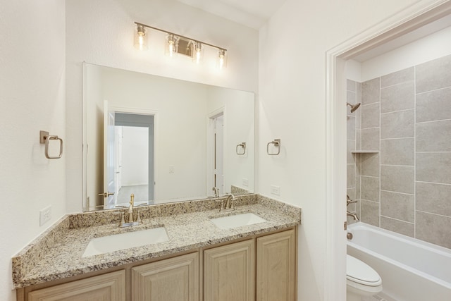 full bathroom featuring vanity, toilet, and tiled shower / bath