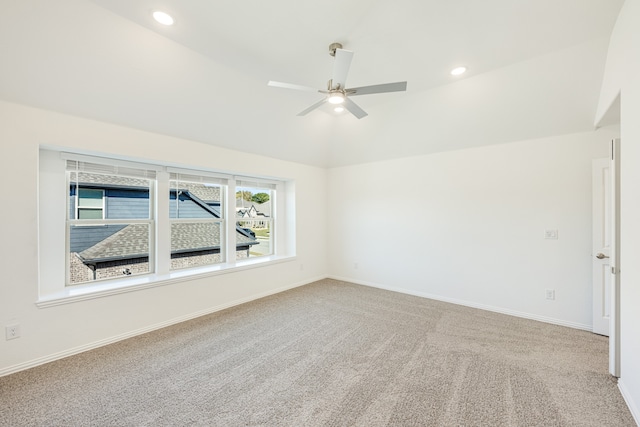 carpeted empty room with ceiling fan and lofted ceiling