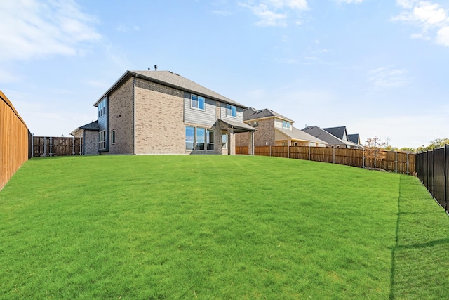 rear view of property with a lawn