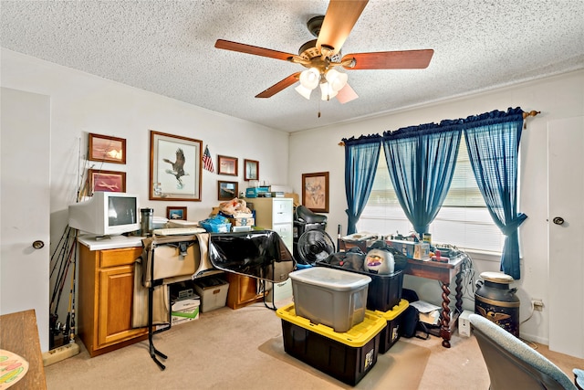 office with a textured ceiling, ceiling fan, and light colored carpet