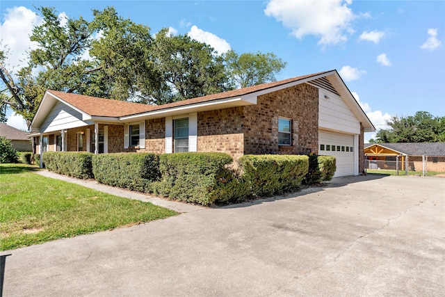 view of front of house with a front yard and a garage