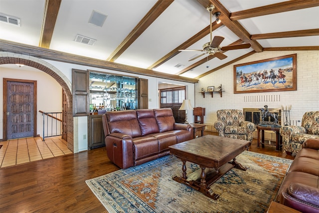 living room featuring wood-type flooring, lofted ceiling with beams, and ceiling fan