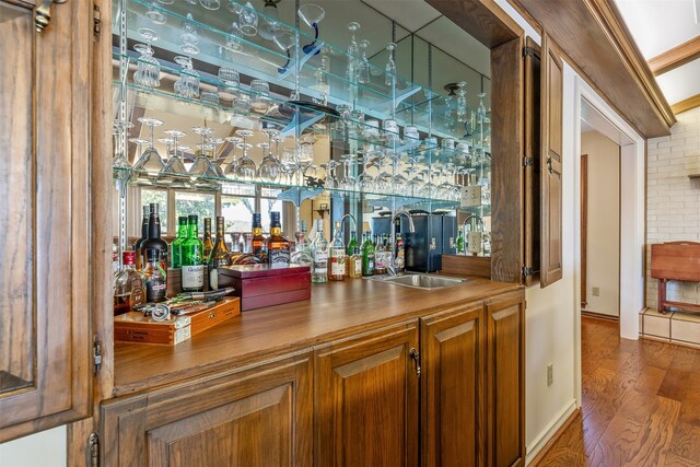 bar featuring dark wood-type flooring and sink