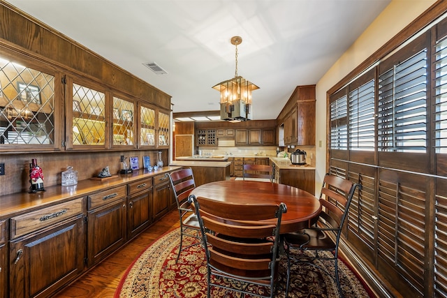 dining room with a notable chandelier and dark hardwood / wood-style flooring