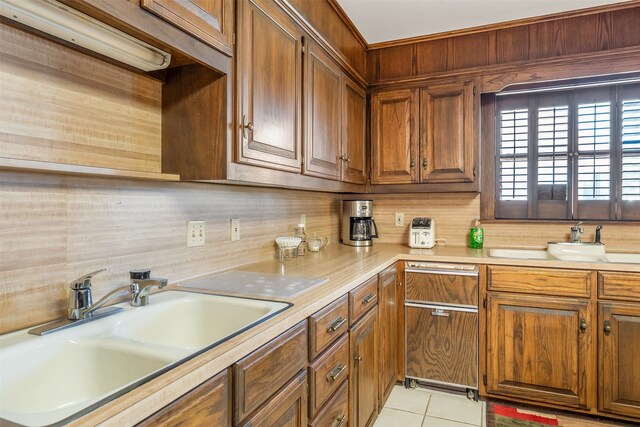 kitchen featuring light tile patterned floors, sink, and decorative backsplash