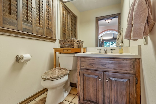 bathroom featuring vanity, toilet, and tile patterned floors