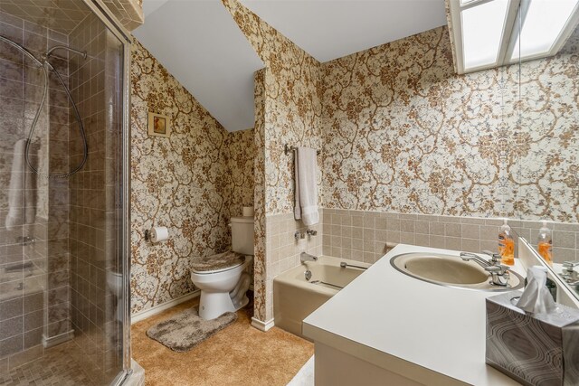 full bathroom with shower with separate bathtub, lofted ceiling, vanity, and toilet