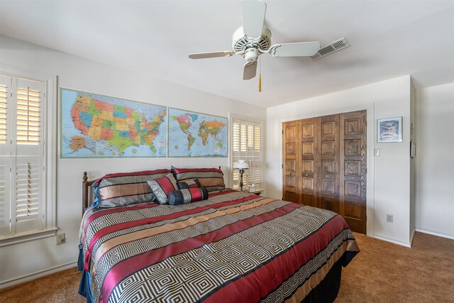 carpeted bedroom featuring multiple windows, ceiling fan, and a closet