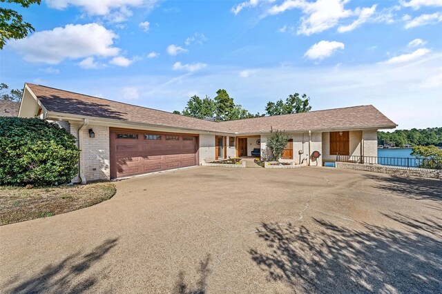 ranch-style home with a water view and a garage