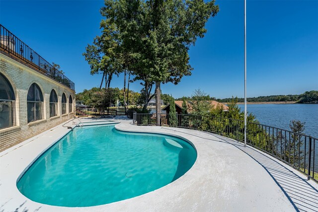 view of pool with a water view