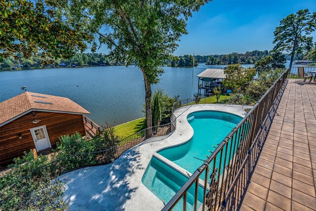 view of swimming pool featuring a patio and a water view