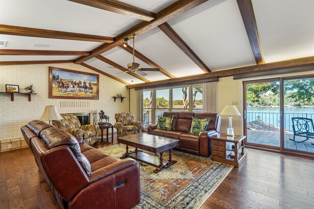 living room with brick wall, a fireplace, lofted ceiling with beams, and dark hardwood / wood-style flooring