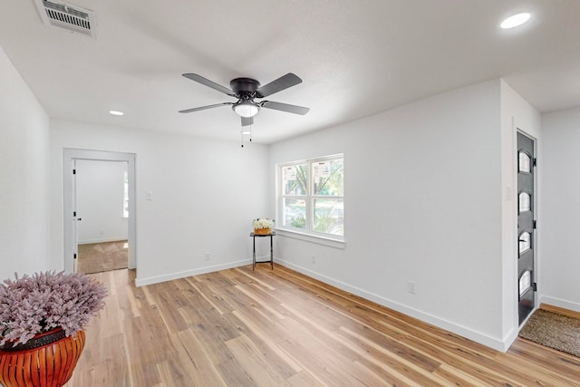 empty room featuring light wood-type flooring and ceiling fan