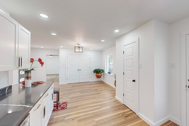 kitchen featuring white cabinets and light hardwood / wood-style flooring