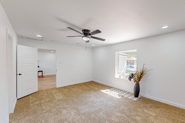 unfurnished room with ceiling fan, carpet, and a textured ceiling