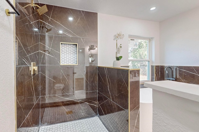 bathroom featuring tile walls, tile patterned flooring, and tiled shower