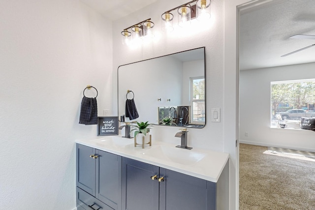 2909 Materhorn Dr, Dallas, TX 75228 - bathroom featuring double vanity, a ceiling fan, baseboards, and a sink