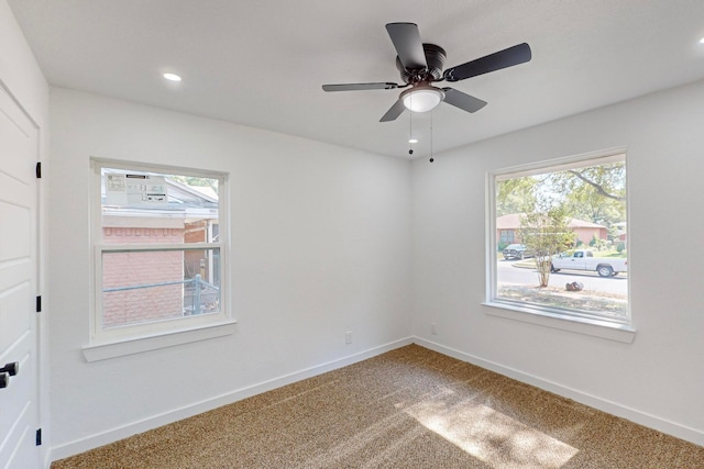 empty room with ceiling fan, carpet flooring, and a healthy amount of sunlight