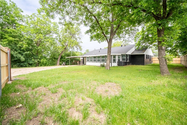 view of yard with cooling unit and a sunroom