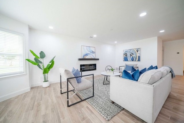4944 Vega Ct W, Fort Worth, TX 76133 - living room featuring light wood-style floors, recessed lighting, a glass covered fireplace, and baseboards