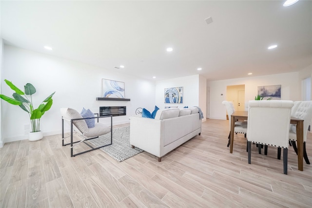 4944 Vega Ct W, Fort Worth, TX 76133 - living room with light wood finished floors, recessed lighting, a glass covered fireplace, and baseboards