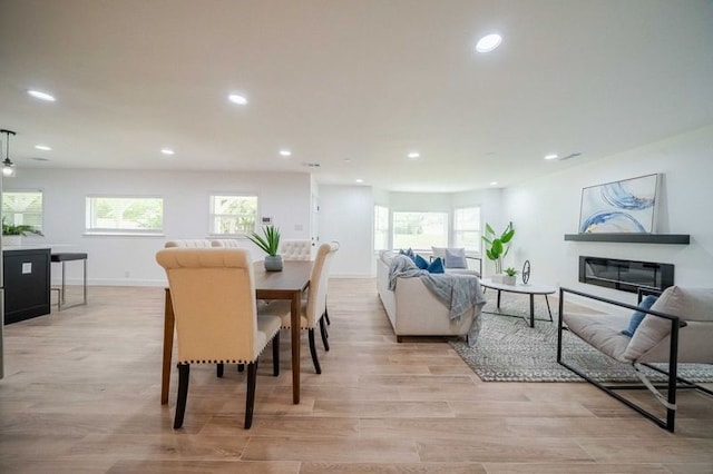 dining room with plenty of natural light and light hardwood / wood-style floors