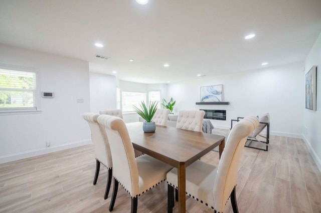 dining room featuring light wood-type flooring and plenty of natural light