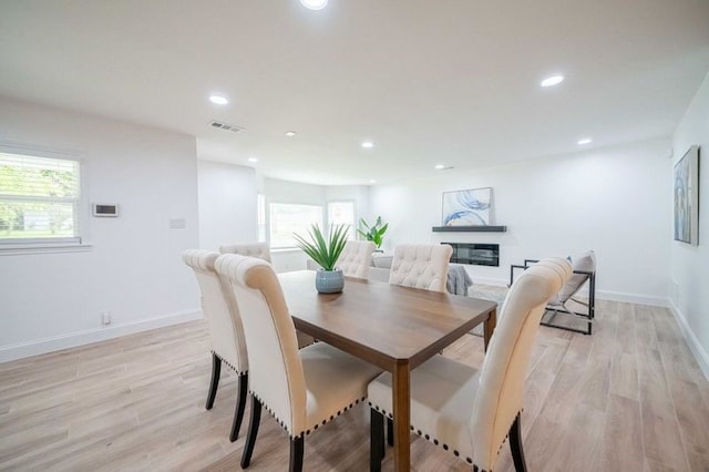 4944 Vega Ct W, Fort Worth, TX 76133 - dining space featuring plenty of natural light, recessed lighting, light wood-type flooring, and a glass covered fireplace