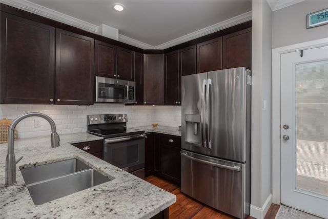 kitchen with dark hardwood / wood-style flooring, light stone countertops, sink, and stainless steel appliances