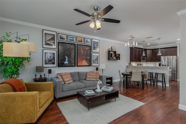 living room featuring crown molding, dark wood-type flooring, and ceiling fan with notable chandelier