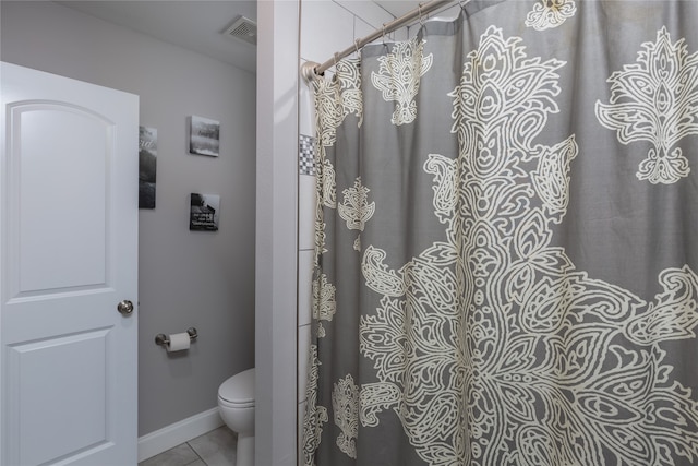 bathroom with tile patterned flooring and toilet