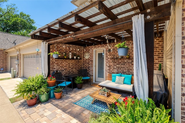 view of patio / terrace featuring a pergola and a garage