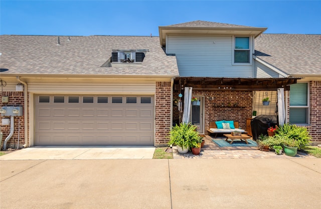 view of front of house featuring a garage and a patio