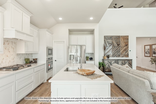 kitchen featuring an island with sink, stainless steel appliances, and light hardwood / wood-style floors