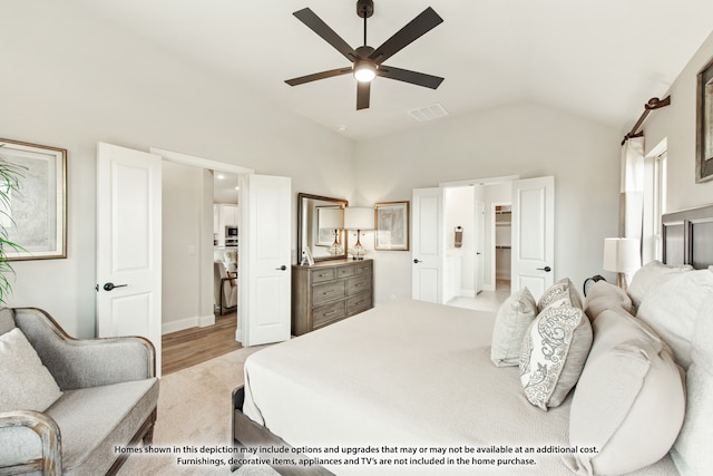 bedroom featuring light wood-type flooring, lofted ceiling, and ceiling fan