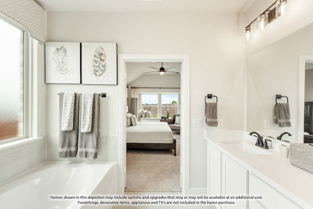 bathroom with ceiling fan, vanity, and a bath