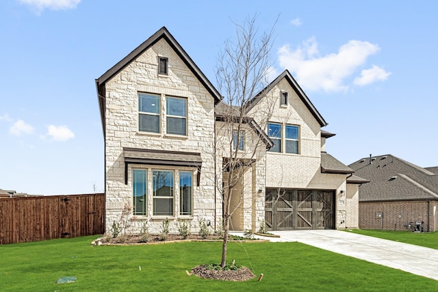 view of front of property featuring concrete driveway, a front lawn, an attached garage, and fence