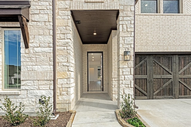 doorway to property with stone siding and brick siding