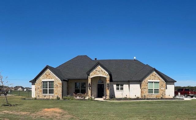 french provincial home with a front lawn