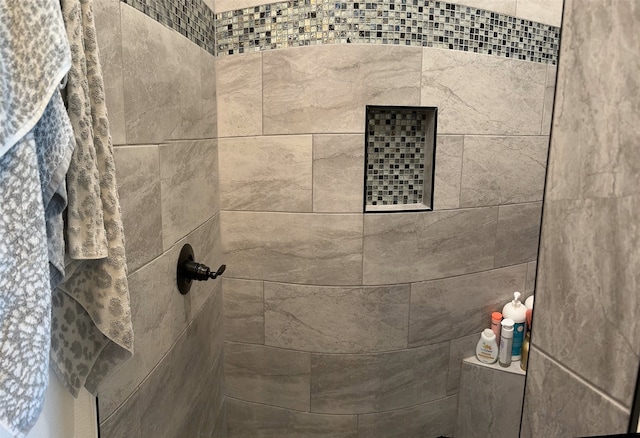 interior details with a tile shower