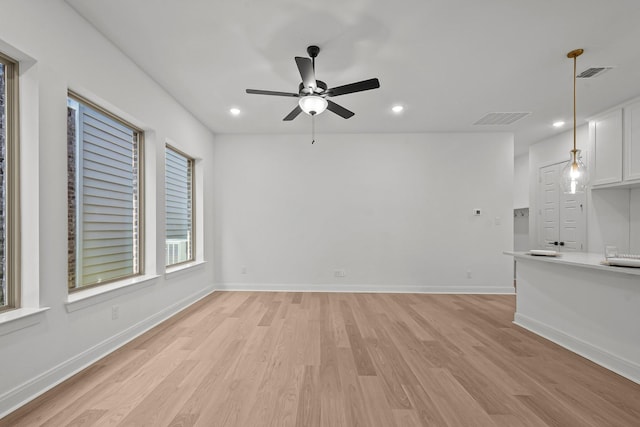 unfurnished living room with ceiling fan and light hardwood / wood-style floors