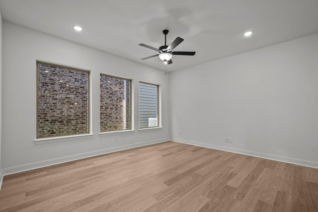 empty room featuring light hardwood / wood-style flooring and ceiling fan